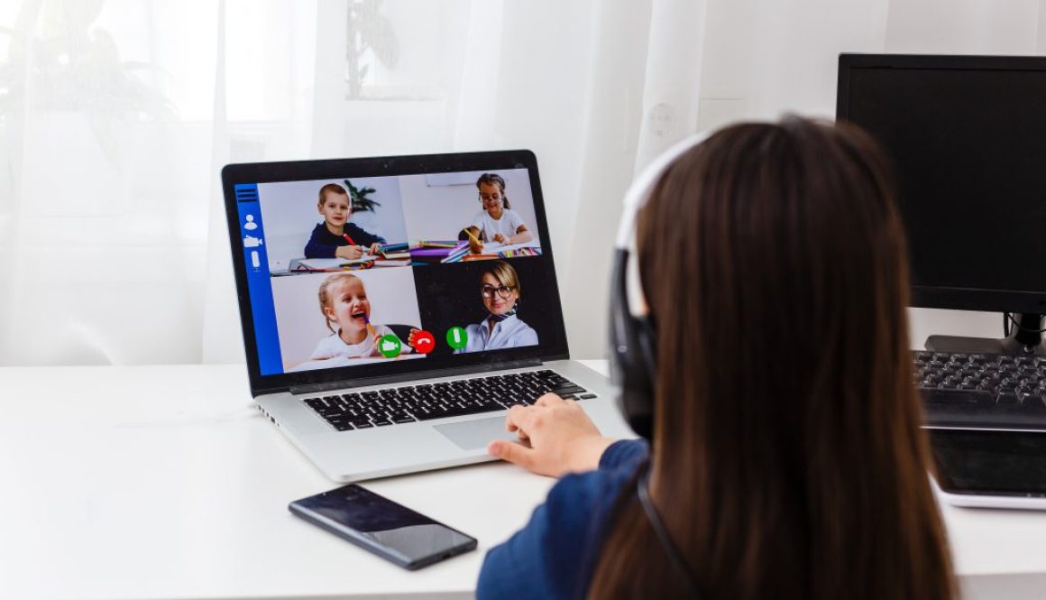 Pretty stylish schoolgirl studying homework math during her online lesson at home, social distance during quarantine, self-isolation, online education concept, home schooler