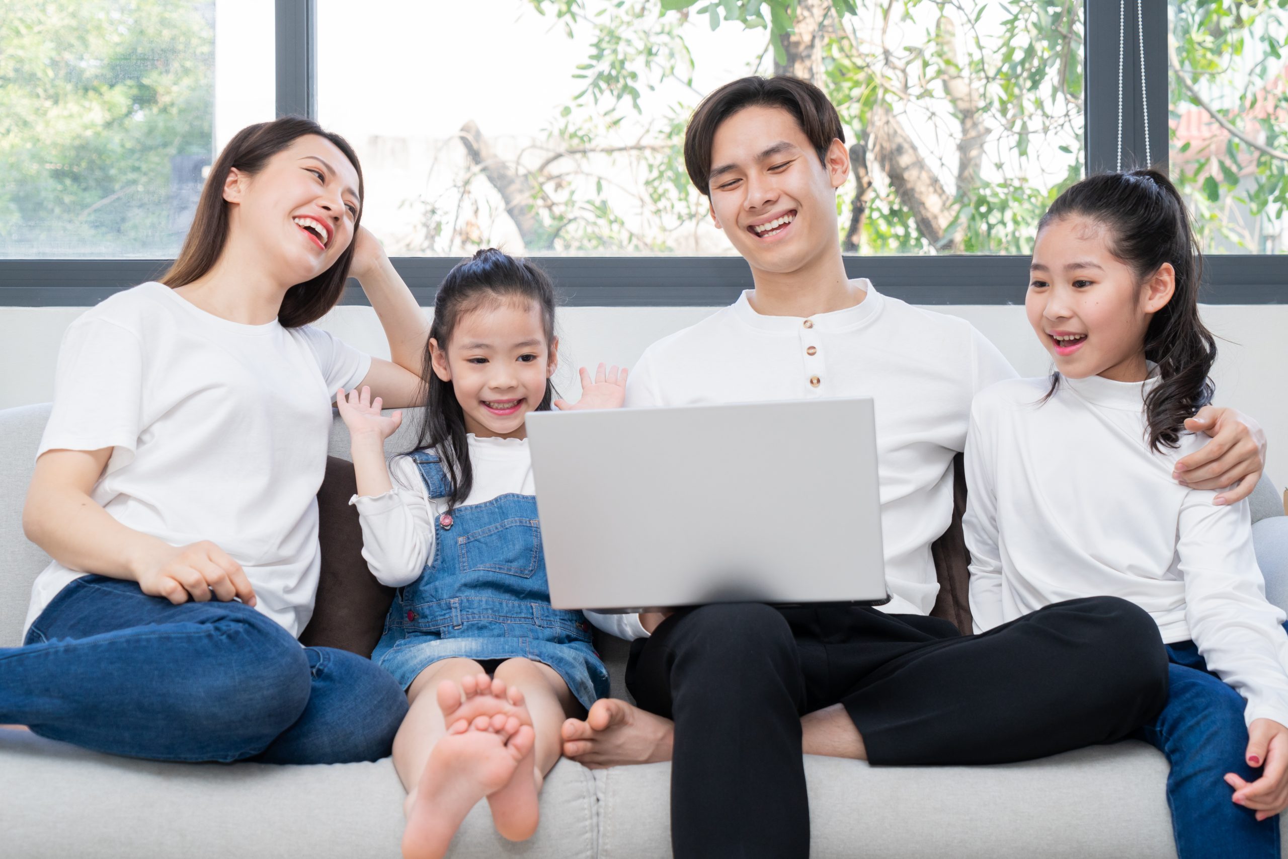 Young Asian family entertained at home in free time